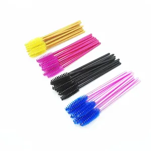 Set of colorful disposable mascara brushes in yellow, purple, black and blue colors.