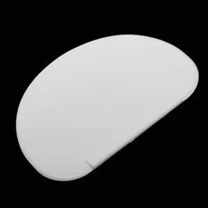 Close-up of white D-shaped plastic cream scraper for cake baking and decorating