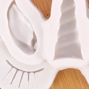 Macro detail view of a white silicone unicorn horn and ear mold for fondant or resin.