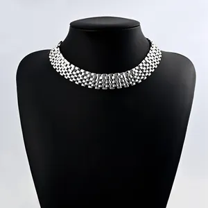 Detail view of a bold punk hip-hop silver wide woven chain necklace displayed on a mannequin
