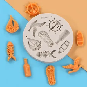 Detail view of multi-cavity silicone mold with ocean-themed sailboat and bird shapes