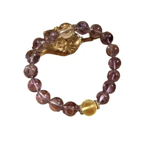Purple crystal beaded bracelet with rainbow flash and yellow quartz accent.