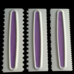 Close-up of professional white and purple serrated cake scrapers for cream decorating