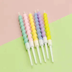 Macro view of six colorful spiral birthday candles with white holders