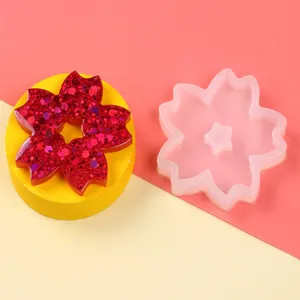 Detail view of cherry blossom silicone mold with a red glitter resin flower sample