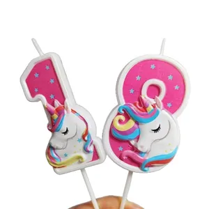 Detailed close-up of pink number 18 birthday candles with cute colorful 3D unicorn design