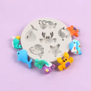 Macro view of marine themed silicone mold with colorful finished resin animal figures