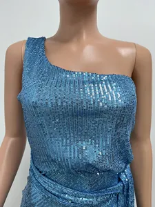 Macro detail of shimmering blue sequins on a one-shoulder elegant pleated evening gown.