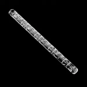 Detail of heart pattern engraved on a clear acrylic rolling pin for fondant baking.