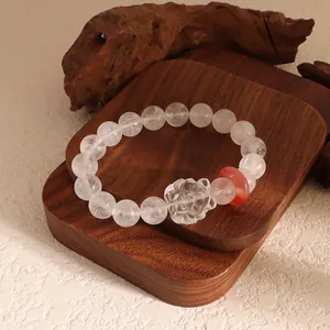 Detailed view of clear crystal beaded bracelet featuring a carved nine-tailed fox charm