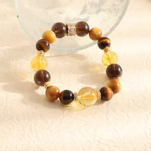 Close-up detail of natural tiger eye and yellow crystal beads with gold crystal spacers