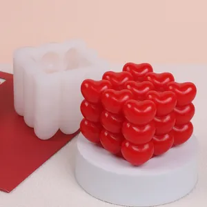 Close-up detail of a 3D heart bubble cube silicone mold with a red finished candle product