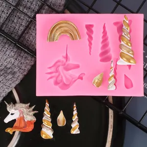 Pink silicone mold with unicorn horns and rainbow shapes for fondant decoration