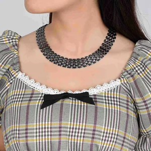 Punk style silver wide chain necklace with hollow links worn by a model.