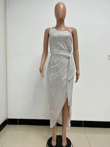 Detailed view of a silver one-shoulder pleated sequin evening dress on a mannequin