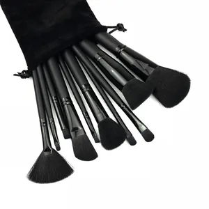Detailed view of 11pcs professional black makeup brush set fanning out of a pouch
