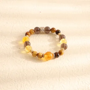 Close-up of a natural citrine and tiger eye stone beaded bracelet with crystal spacers