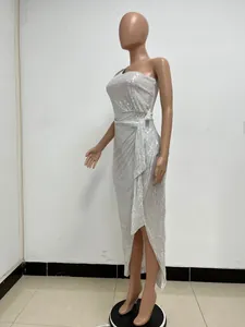 Elegant silver one-shoulder sequin dress with side slit and waist tie detail.