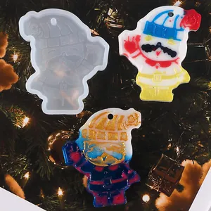 Detailed view of the DIY snowman silicone mold alongside finished colorful resin ornaments