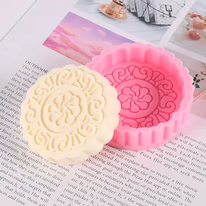 Detailed macro view of a pink mooncake silicone mold and finished white wax candle