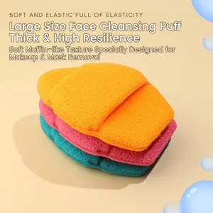 Close-up detail of three stacked XXL thick face wash sponges in orange pink and teal