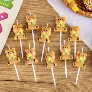 Detailed shot of cute brown bear-shaped birthday candles for festive cake decoration