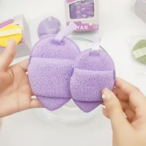 Close-up detail of soft purple facial cleansing sponges showing porous sponge texture.