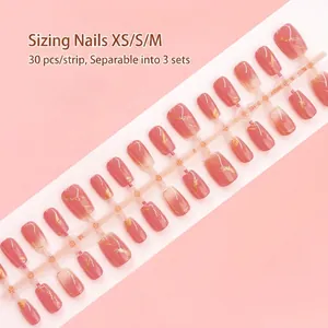 Set of 30 pink marbled press-on nail strips with gold foil detail for DIY manicure art