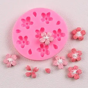 Close-up of pink cherry blossom silicone mold with detailed fondant flower accents
