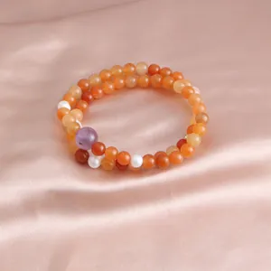 Detail of a double-strand beaded bracelet with orange carnelian and amethyst beads