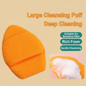 Macro view of XXL thick orange cleansing sponge producing dense white foam