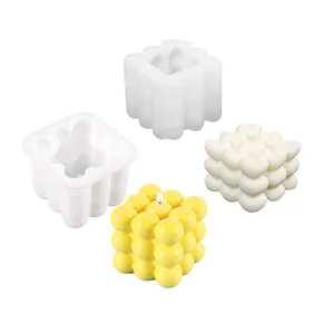 Silicone molds for DIY candle making featuring bubble and heart cube designs on white.