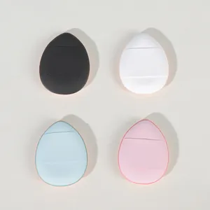 Detailed view of four colorful mini finger cushion puffs for precise makeup application.