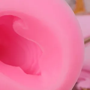 Close-up detail of pink silicone mold for unicorn horn and ear decorations.