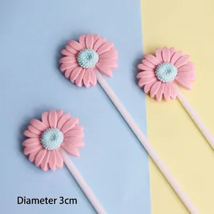 Macro detail of three pink daisy resin cake toppers with 3cm diameter flower heads