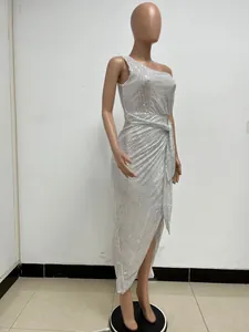 Side view of elegant silver sequined one-shoulder evening dress with waist tie and slit