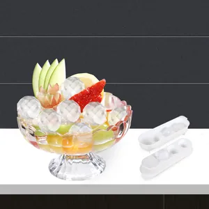 Detailed view of faceted diamond ice spheres in a fruit bowl with plastic ice molds