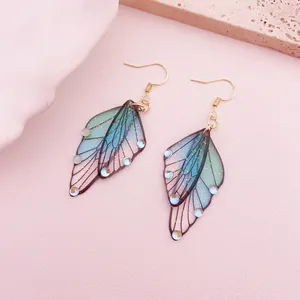 Exquisite detail of vintage gradient butterfly wing earrings with glitter and blue beads