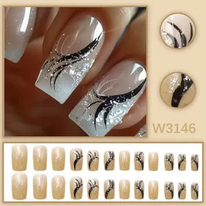 Detail view of ice transparent nude French press-on nails with black ribbon and silver glitter.