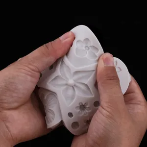 Close-up of flexible white silicone mold with floral patterns for fondant cake decoration