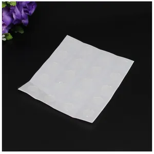 Detailed view of clear circular double-sided adhesive glue dots for figurine stands