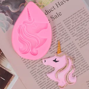 Detailed view of pink unicorn silicone mold and finished resin unicorn piece on a magazine