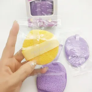 Close-up view of a 3-piece facial cleansing sponge puff set being held by a hand