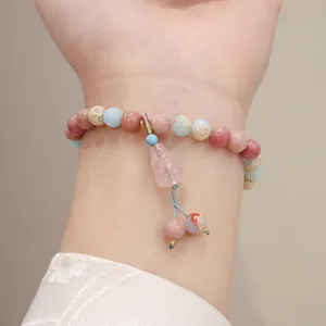 Detailed view of handmade natural stone bracelet with rose quartz and strawberry quartz beads