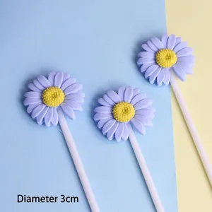 Macro detail of three purple daisy resin cake toppers measuring 3cm in diameter.