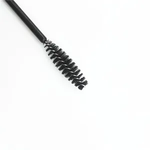 Macro close-up of professional disposable mascara brush head with black spiral bristles.