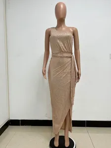 Elegant champagne gold one-shoulder sequin maxi dress with pleated waist tie detail.