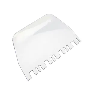 White plastic serrated cream scraper tool for cake decorating and texture creation