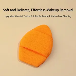 Macro view of a large orange soft sponge glove for deep facial cleansing and makeup removal