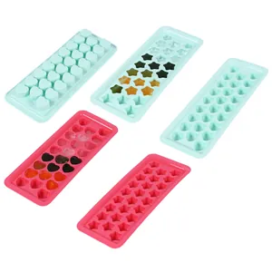 Detail view of heart and star shaped ice cube trays in pink and mint green for baby food